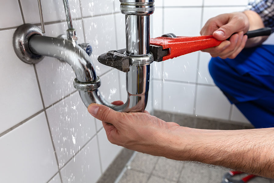 Professional plumber performing service