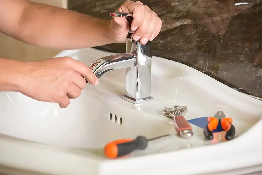 Plumber performing faucet installation